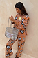 Tan Sun Copenhagen Jumper and trousers featuring sun and swirl motifs in a soft stretch knit co-ord.