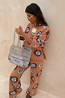 Tan Sun Copenhagen Jumper and trousers featuring sun and swirl motifs in a soft stretch knit co-ord.