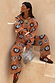 Tan Sun Copenhagen Jumper and matching trousers with blue sun motifs in a soft knit co-ord, styled with leopard trainers.