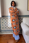 Tan Sun Cardigan with hand-painted sun and swirl motifs in an oversized longline knit silhouette.