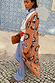 Thumbnail for Tan Sun Cardigan with hand-painted sun motifs and an oversized fit, styled with blue striped trousers.