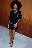 Thumbnail for Black Vegan Leather Mini Jaspre wrap skirt and embroidered Tarot cardigan with silver heels.