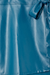 Teal vegan leather Mini Jaspre Skirt detail showing the wrap tie waist and supple fabric texture.