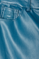 Close-up of teal vegan leather trousers featuring a detailed embroidered logo on the pocket and stitching.