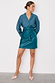 Teal Vegan Leather Mini Jaspre Skirt with a wrap waist, styled with a matching teal shirt and pointed pink heels.