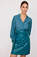 Teal Vegan Leather Mini Jaspre Skirt Petite on a model, featuring a wrap waist and matching teal shirt.