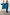 Thumbnail for Model wearing the Teal Vegan Leather Mini Jaspre Skirt Petite with a matching teal shirt next to a model in trousers.