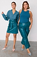 Model wearing the Teal Vegan Leather Mini Jaspre Skirt Petite with a matching teal shirt next to a model in trousers.