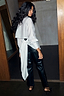 White Studded Tie Back Shirt with silver stud detailing and a large back bow, styled with black studded trousers.