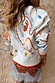 Cream Cheryl Cardigan in Tigress Print with colourful embroidery and contrast trims, shown from the back.
