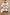 Thumbnail for Cream knit Cheryl Cardigan with orange contrast trims and embroidered tigress and palm motifs on a wooden hanger.