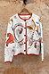 Cream knit Cheryl Cardigan with orange contrast trims and embroidered tigress and palm motifs on a wooden hanger.