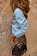 Blue Tigress Cardigan in pale blue knit with orange embroidery and contrast stitching on the sleeve.