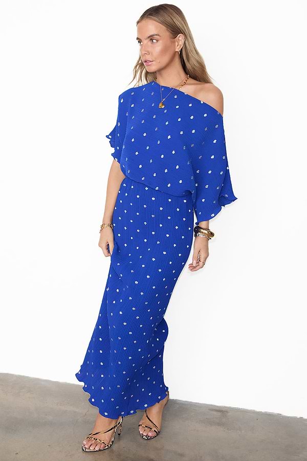 Cobalt Blue Tilly Plisse Dress with silver dots, asymmetric sleeves, and an off-the-shoulder neckline.