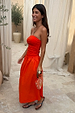 Tomato Lola Mid-axi Dress in red with a ruched strapless bodice and cotton skirt, styled for a vacation look.