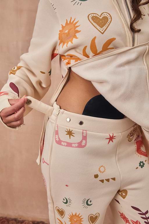 Cream Sundazed Accessible Joggers featuring side zips and poppers for treatment access and iconic prints.
