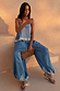 Blue Lace Balloon Trousers in washed blue satin with lace trims and elasticated ankles, styled outdoors at sunset.