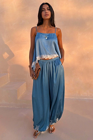 Blue Lace Balloon Trousers in washed blue satin with delicate lace trims and a fluid wide-leg silhouette.