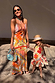 Dolce Vita Valeria slip midi dress with sun motifs and patchwork panels in orange, blue and pink tones.
