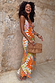 Dolce Vita Valeria slip midi dress featuring a sun print and geometric patchwork in orange, blue and pink tones.
