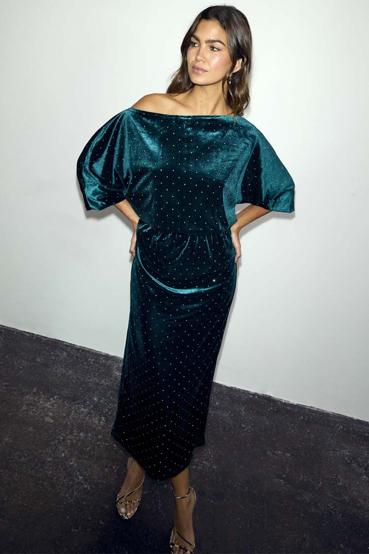 Emerald Velvet Tilly Dress with an off-the-shoulder neckline and diamante details, worn by a model.