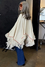 Thumbnail for Cream Western Knitted Cape with red embroidery and fringe hem, styled with dark denim jeans.