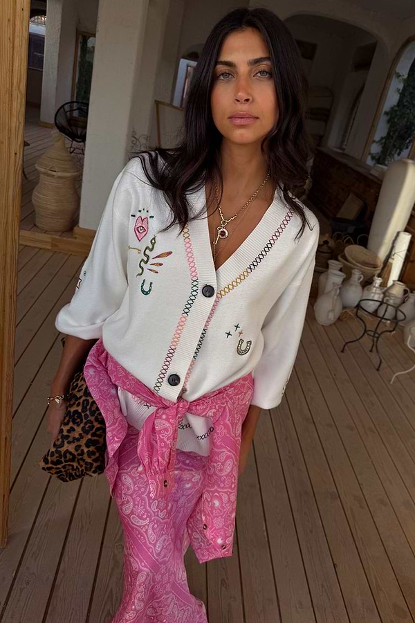 Cream Western Martha Cardigan with colourful cross-stitch and western motifs, paired with a pink paisley skirt.