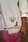 Cream Western Martha Cardigan featuring embroidered western motifs and colourful criss cross stitch detailing on soft knit.