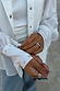 Chunky Deloris Whistle Ring with red, green and turquoise gemstones, styled on a model in a white studded shirt.