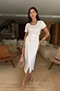 White Jesse Jersey Wrap Dress with a tee-style bodice and adjustable waist tie, accessorised with gold jewellery.