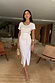 White Jesse Jersey Wrap Dress with short sleeves and wrap tie detailing on a model in a living room.