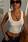 White Scoop Neck Rib Tank in a ribbed fabric, featuring a scoop neckline and styled with dark denim and gold jewellery.
