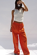 White Ribbed Tank styled with orange trousers for a casual London look, shown on a model taking a selfie.