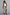 Thumbnail for White Ribbed Tank worn with a silver sequin wrap skirt and sunglasses, leaning against a white wall.