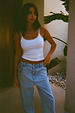 White Teddy Vest featuring mesh trim detailing, styled with light-wash blue denim jeans.