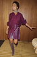 Burgundy Mini Kilt Skirt in vegan leather with side buckle fastening and pleats, styled with a matching wine shirt.