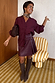 Burgundy Mini Kilt Skirt in wine vegan leather with side buckles and pleats, styled with a matching shirt and boots.