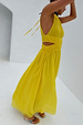Yellow Ella Dress featuring pleated fabric, side cut-outs and a flowy midaxi silhouette against a white wall.
