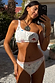 Cream Palma high waist bikini bottoms with orange crochet trim and illustrative print, worn with a one-shoulder top.