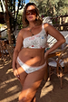Cream Palma high waist bikini bottoms and matching top with orange crochet stitch trim and hand-drawn vacation prints.