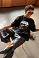 Black Fruit Shop Sweatshirt with a graphic print, styled with black leather-look culottes and oversized sunglasses.