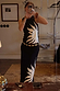 Black Sol Tank Top with a hand painted sun print, styled with a matching skirt and gold belt in a mirror selfie.