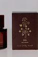 NFD Eau De Parfum 001 burgundy box with gold foil palm tree and star illustrations beside an amber glass bottle.