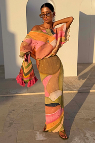 Abstract Beaded Fringe Bag with multicoloured glass beads and pink tassels, styled with a matching dress on vacation.