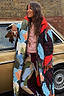 Thumbnail for Longline quilted Navy Abstract Coat with reversible leopard print lining, worn by a model by a vintage car.