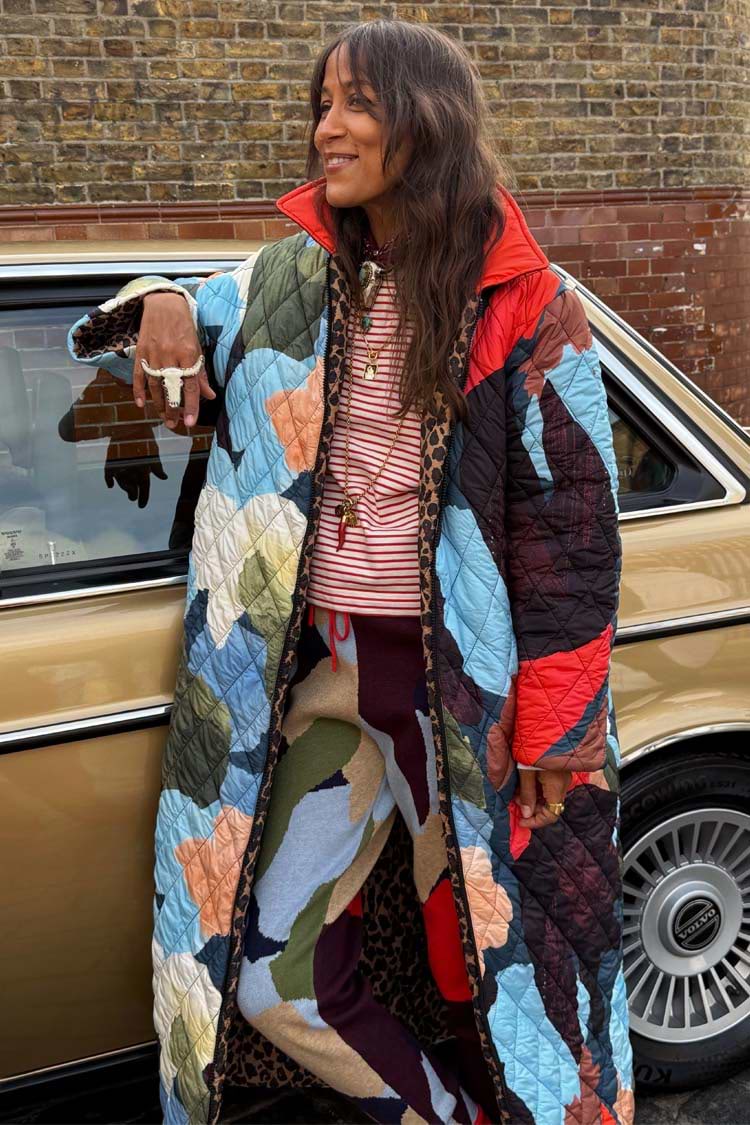 Longline quilted Navy Abstract Coat with reversible leopard print lining, worn by a model by a vintage car.