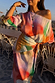 Abstract Jem Dress with a multicoloured print, off-the-shoulder neckline and cinched wrap waist detail.