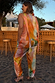 Abstract Lily Top and trousers in a multicoloured print, styled as a curve fashion co-ord in an outdoor setting.