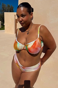 Abstract Ruched Bikini Top in sunset tones with gathered cups and bead-trim straps, shown for inclusive sizing.