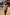 Thumbnail for Abstract V Front Bikini Brief in a sunset-toned painterly print with a V-shape waistline, shown on a beach.